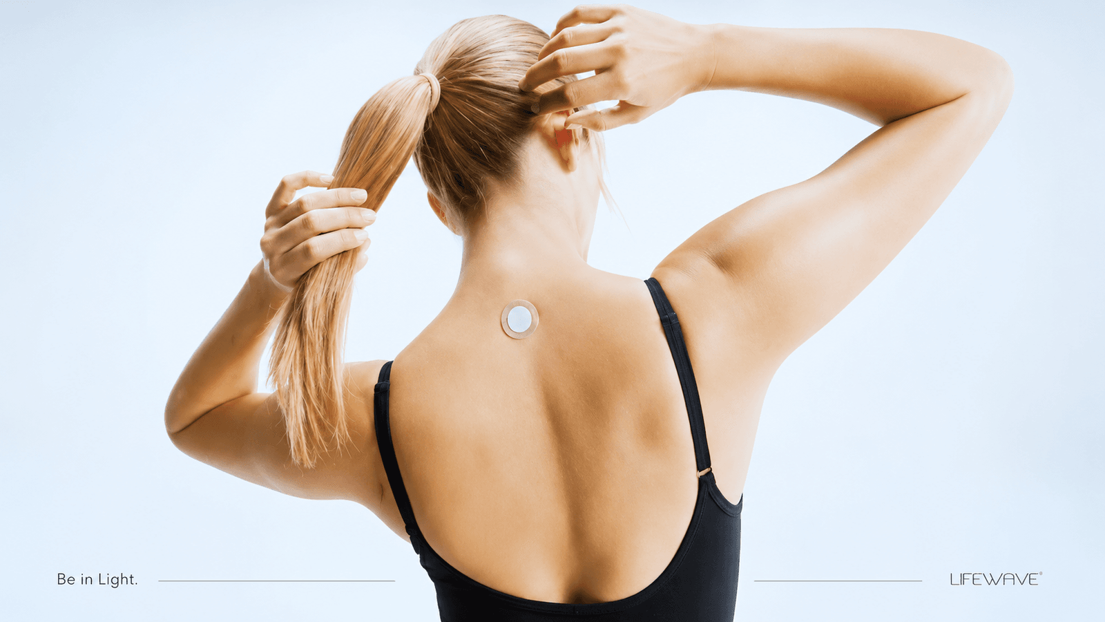 Woman wearing a small non-transdermal wearable light patch